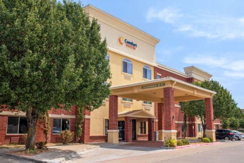 a front view of a hotel with a tree at Comfort Suites McKinney-Allen in McKinney