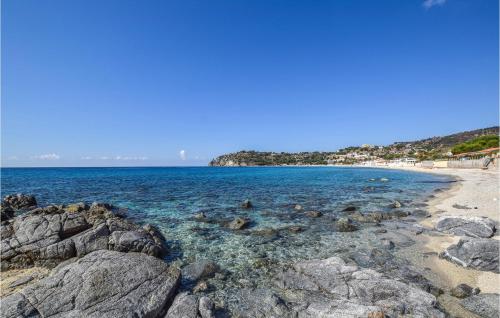a beach with rocks and the ocean on a clear day at Amazing Home In Polistena With 3 Bedrooms And Wifi in Polistena