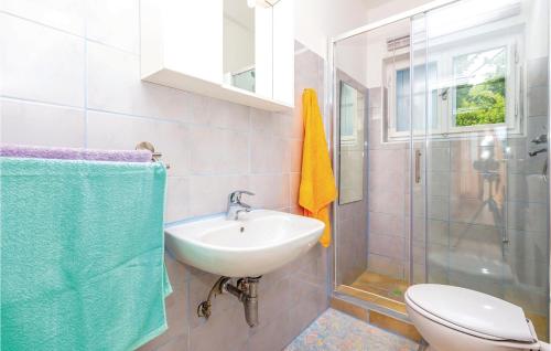 a bathroom with a sink and a toilet and a shower at 3 Bedroom Pet Friendly Home In Dramalj in Dramalj