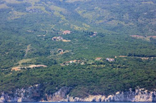 a view of a mountain with houses on it at Holiday house with a swimming pool Zagore, Opatija - 7922 in Zagorje