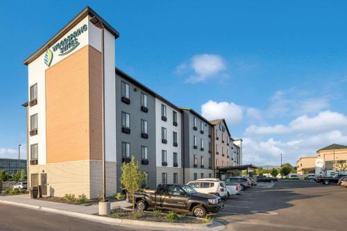 a building with a truck parked in a parking lot at WoodSpring Suites Meridian in Meridian