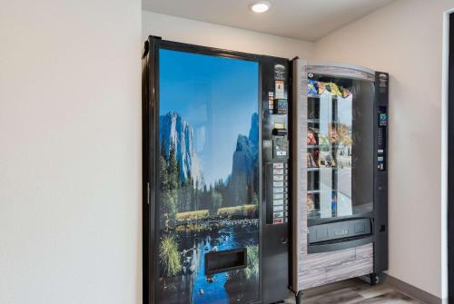 a vending machine with a picture of a city at WoodSpring Suites Meridian in Meridian
