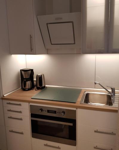 a kitchen with a sink and a stove at 5210 Meereslust in Dahme