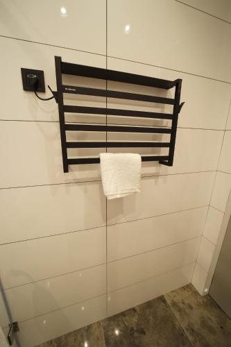 a towel hanging from a towel rack in a bathroom at AVENUE RESIDENCE by AY North Avenue in Yerevan