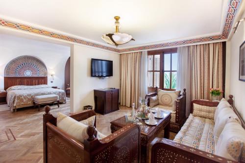 a living room with a bed and a couch at Grand Hotel Villa de France in Tangier