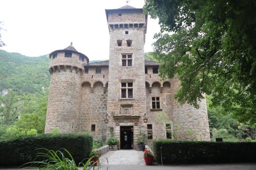 a castle with two towers on top of it at Château De La Caze Piscine & Spa - Ste Enimie in Sainte-Énimie