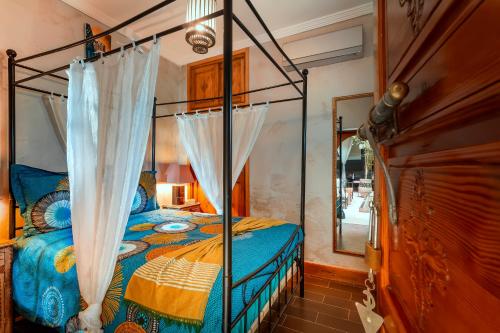 a bedroom with a bed with a canopy at Riad Rodaina in Marrakesh