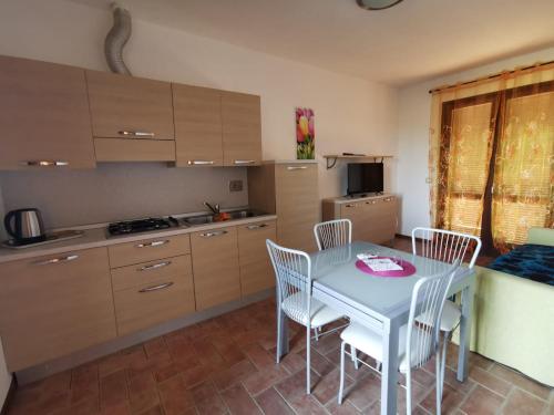 a kitchen with a table and chairs in a room at Residenza Principina in Principina Terra