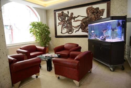 a waiting room with chairs and a fish tank at Hotel Soydan in Afyon