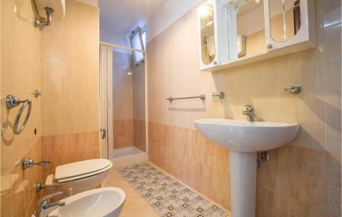 a bathroom with a toilet and a sink at Amazing Apartment In Ricadi With House Sea View in Ricadi