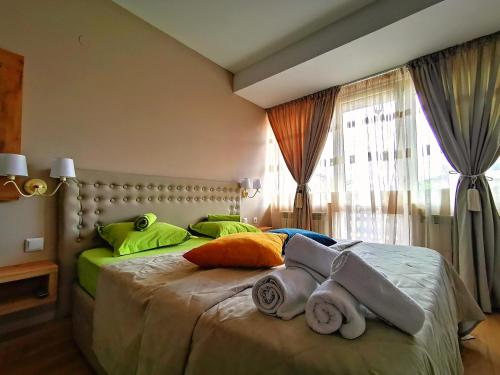 a bedroom with a large bed with colorful pillows at Zigen House in Bansko