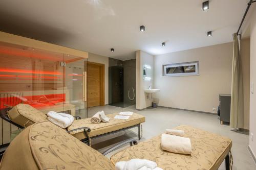 a living room with two couches and a table at WeinZeit Chalets in Gamlitz