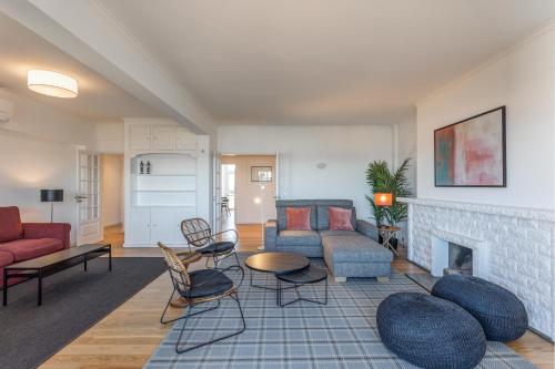a living room with a couch and a fireplace at Belvedere TM Flat With a Magnificent View in Lisbon