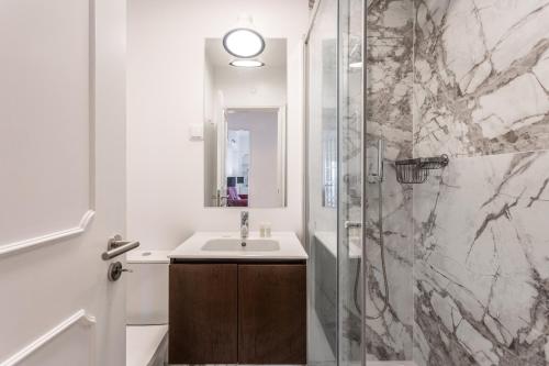 a bathroom with a sink and a shower at Belvedere TM Flat With a Magnificent View in Lisbon