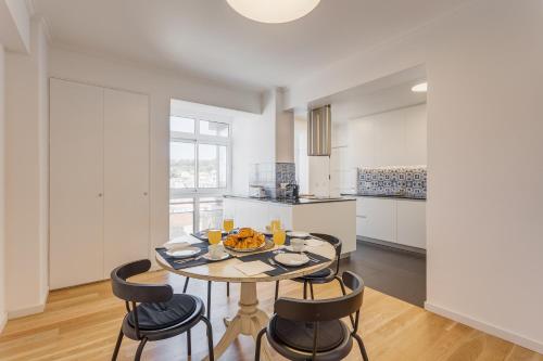 a dining room with a table and chairs in a kitchen at Belvedere TM Flat With a Magnificent View in Lisbon