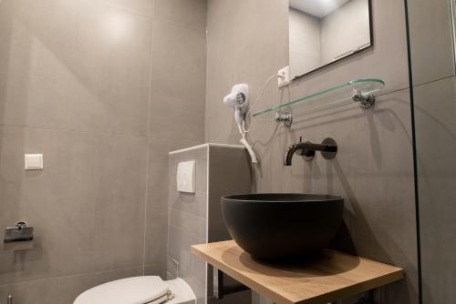 a bathroom with a shower and a bowl sink at Hotel Cataleya in Almere