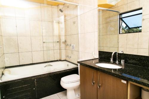 uma casa de banho com um lavatório, um WC e uma banheira em Hotel Bemtevi em Farroupilha