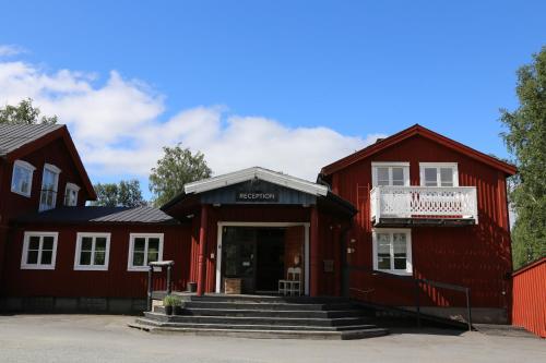 a red building with stairs in front of it at Hemavans Wärdshus in Hemavan