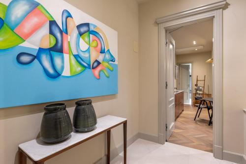 a living room with a painting on the wall at Martis Forum Heritage Hotel & Residence in Poreč