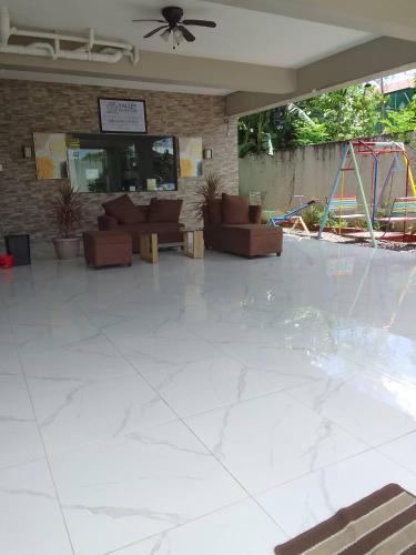 a large empty lobby with a playground in the background at Guest House in Cainta Rizal in Cainta