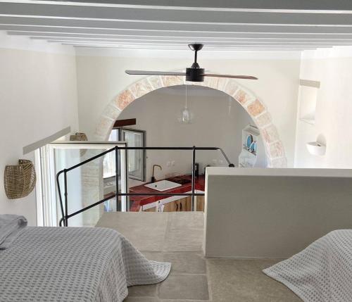 a bedroom with a bed and a ceiling fan at Fournos in Kimolos