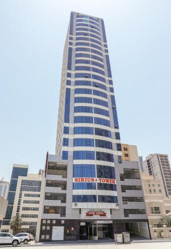 a tall building with a sign on the front of it at SIRIUS TOWER in Juffair