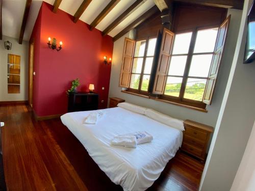 a bedroom with a white bed with two towels on it at La Posada de Abanillas in Abanillas