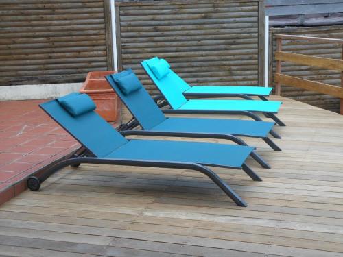 a group of blue chairs sitting on a deck at Carline in Le Diamant