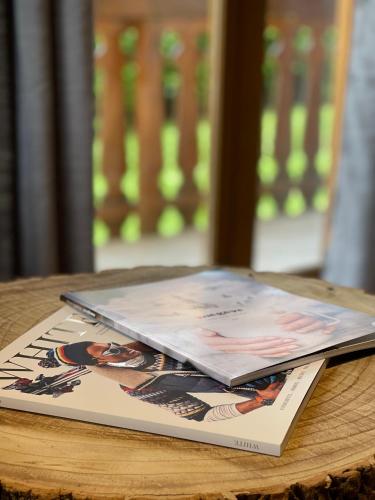 a book sitting on top of a wooden table at Marmotte du Jaillet Cosy and charmant appartement in Demi-Quartier