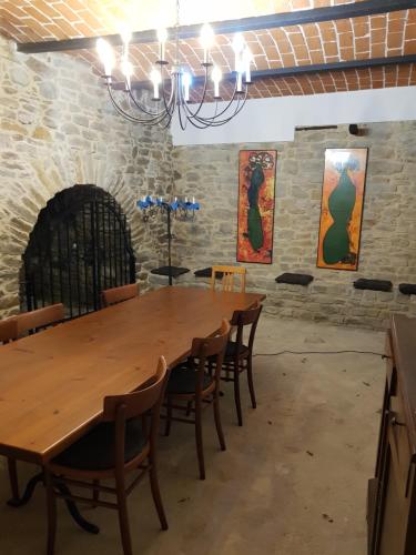 a dining room with a wooden table and chairs at B&B Casa Fossello in Montabone