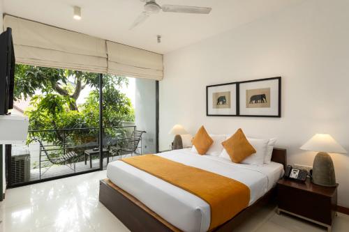 a bedroom with a large bed and a balcony at Rockwell Colombo in Colombo