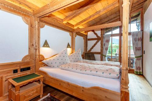 a bedroom with a bed in a wooden room at Haus Eder in Saalfelden am Steinernen Meer