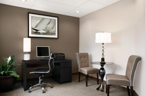 an office with a desk and a computer and chairs at Super 8 by Wyndham Portland Airport in Portland