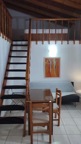a room with a staircase and a table and a bed at Apartments Barbie in Rethymno Town