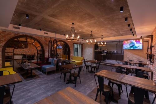 a restaurant with tables and chairs in a room at Merida Hotel Baku in Baku