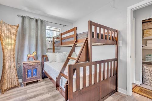a bedroom with a bunk bed and a staircase at Downtown Single Family Modern Bungalow close to beaches and dining home in Sarasota