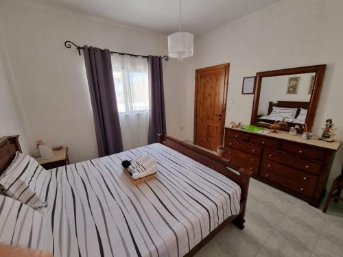 um quarto com uma cama com um espelho e uma cómoda em Mamina's House em il-Baħrija