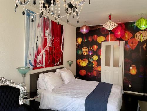 a bedroom with a bed with lamps and lanterns at B&B in de Steenstraat in Zwolle