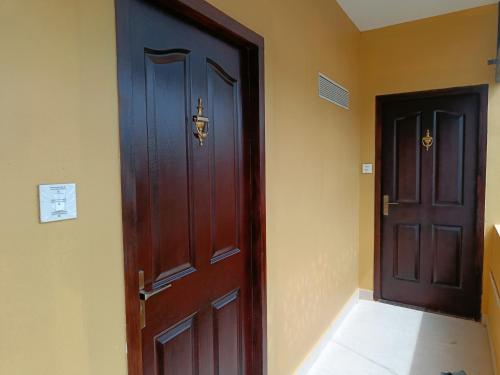 a wooden door in a room next to a door at Hotel Comorin Grand in Kanyakumari
