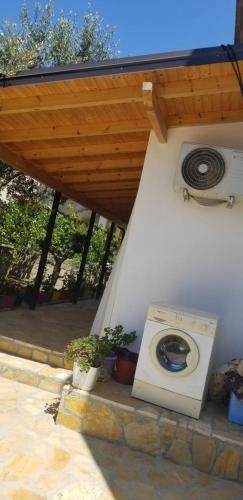 a washing machine sitting on a patio under a roof at Vila Sita in Vlorë