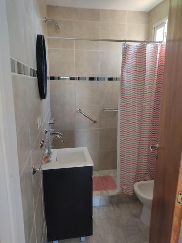 a bathroom with a sink and a shower curtain at Villa Aurora in Potrero de Garay