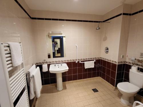 a bathroom with a toilet and a sink at The Royal Inn in St Austell