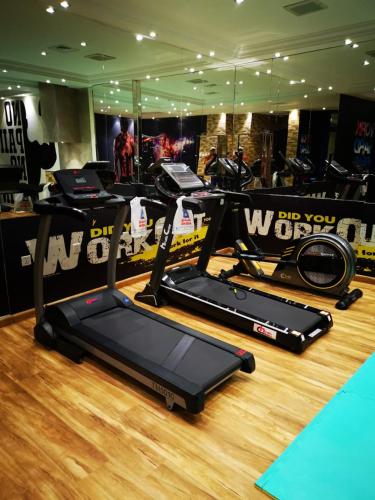a gym with two treadmill machines on a wooden floor at Qasr Al Sahab in Khamis Mushayt