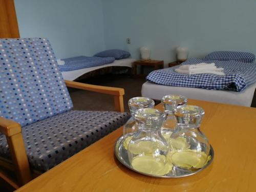 a table with two glass vases on top of it at Hotel Chytrov in Volfířov
