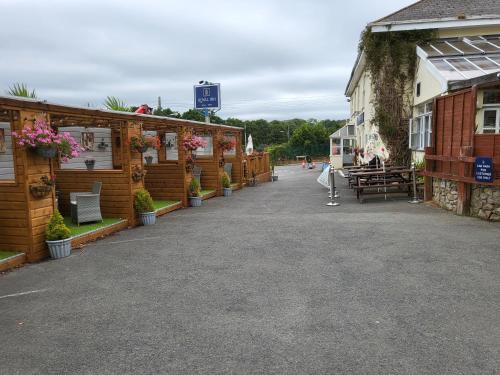 a row of buildings with plants and flowers on them at The Royal Inn in St Austell