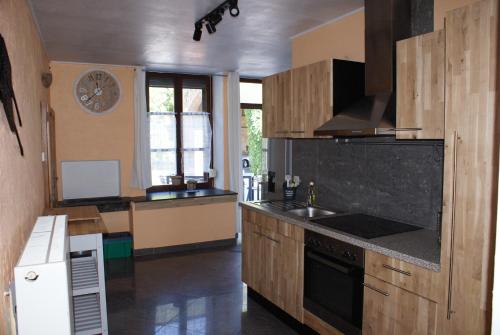 a kitchen with a sink and a stove top oven at Café du Pêcheurs in Bouillon