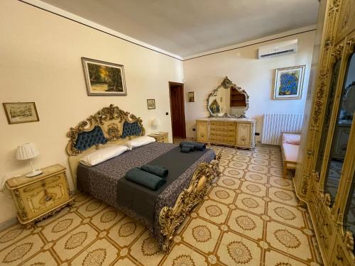 een slaapkamer met een kingsize bed en een spiegel bij Villa Mastricale in Putignano