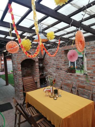 a table with umbrellas hanging from a ceiling at Wolna Chwila in Maków