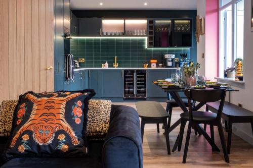 a living room with a couch and a table in a kitchen at Ultimate glam, vintage central pad. Cool 70s bar. in Bournemouth