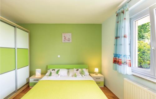 a bedroom with a yellow bed and a window at Awesome Home In Vinjani Donji With 4 Bedrooms, Wifi And Outdoor Swimming Pool in Crna Gora